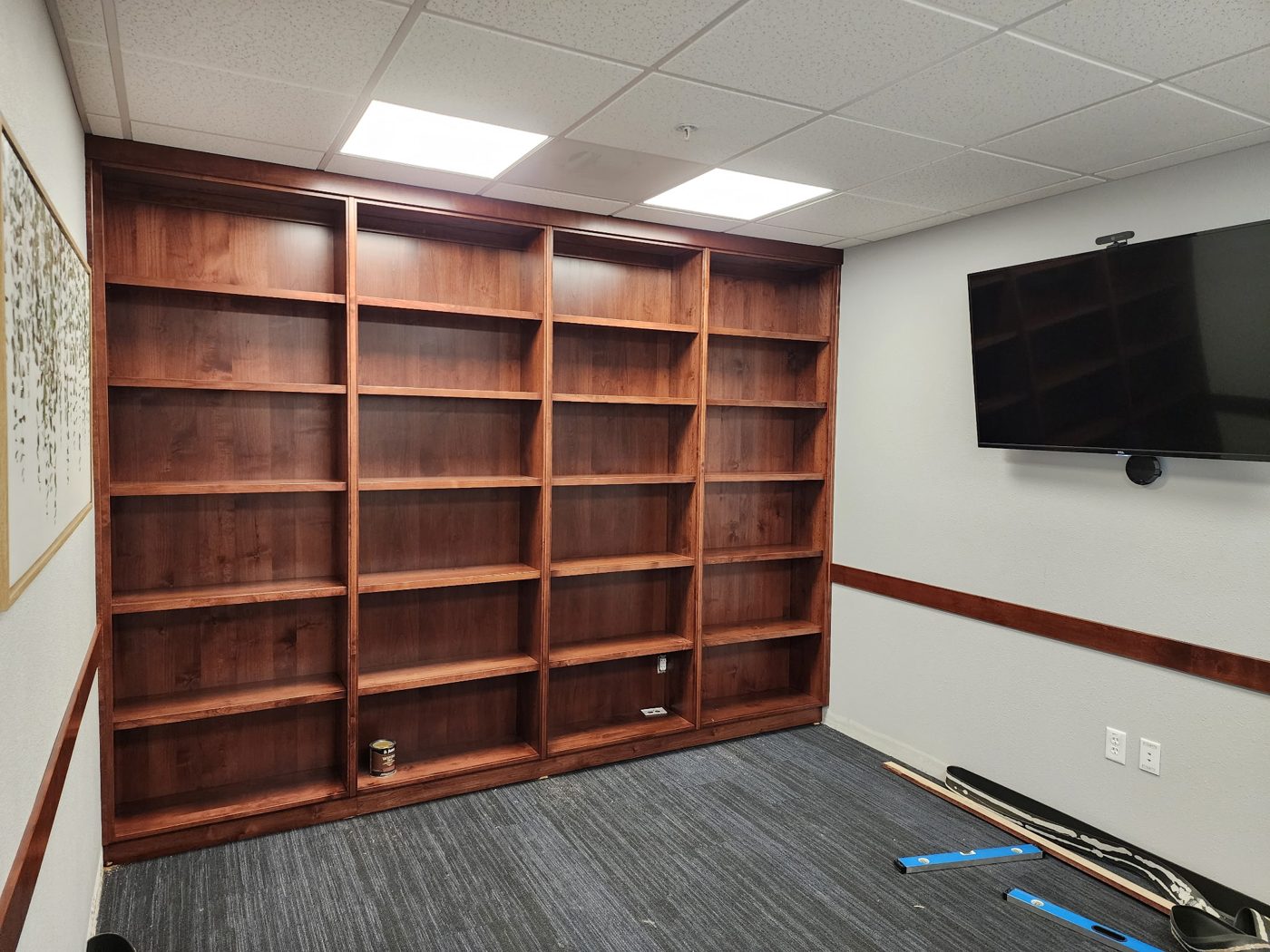 Large custom built-in bookshelf wall in a wood tone finish