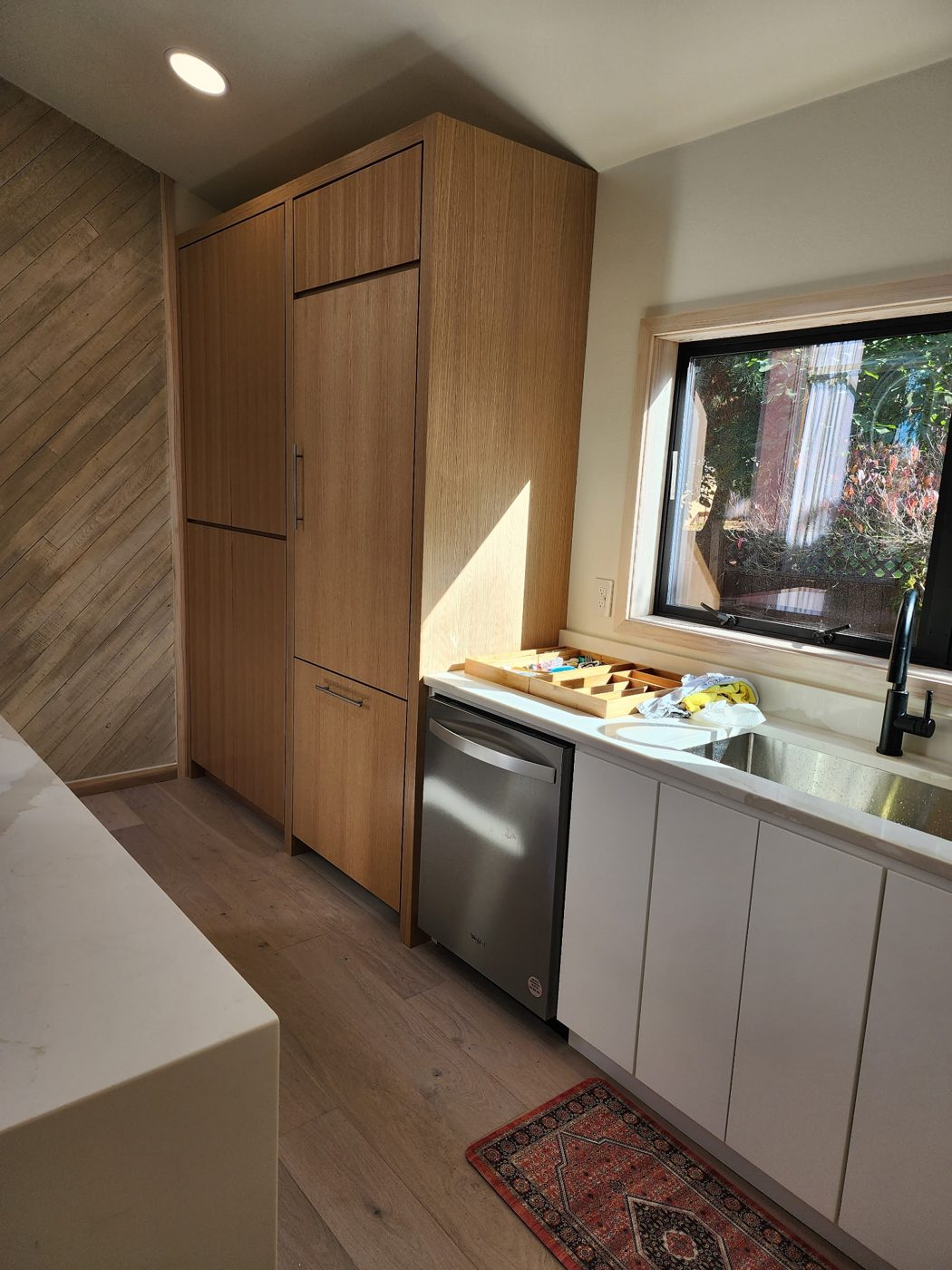 Modern kitchen with flat panel wood cabinetry and integrated appliances